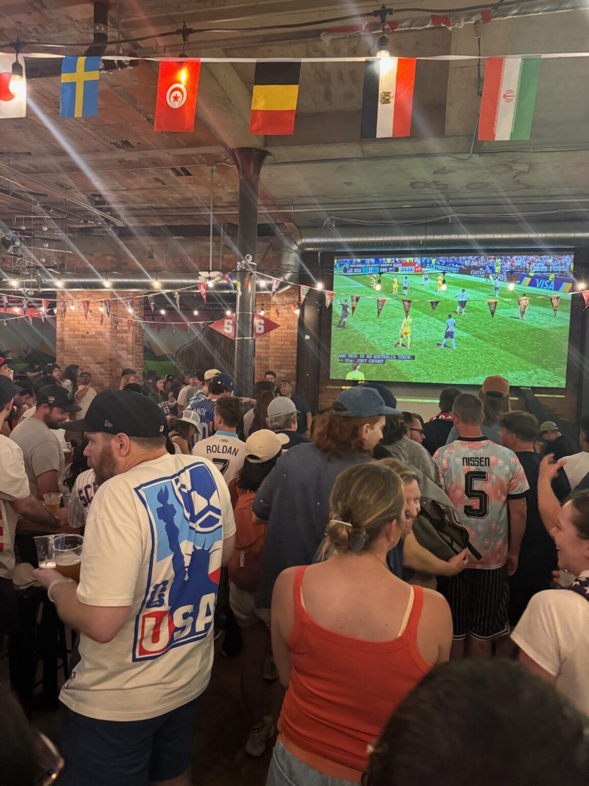 An excited group tunes in for the World Cup match at Flatstick Pub
