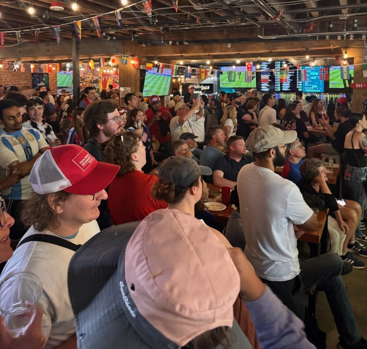 A group of World Cup fans watch a match at Flatstick Pub